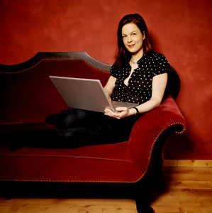 Woman on sofa with laptop computer